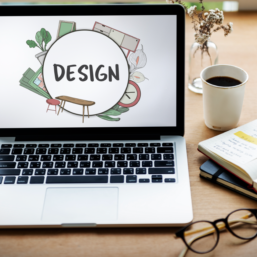 Geeakbite Website Design Laptop with the word "design" written on the screen